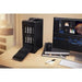 Black G-RAID Shuttle opened with 8 inserted disks next to a monitor on a desk